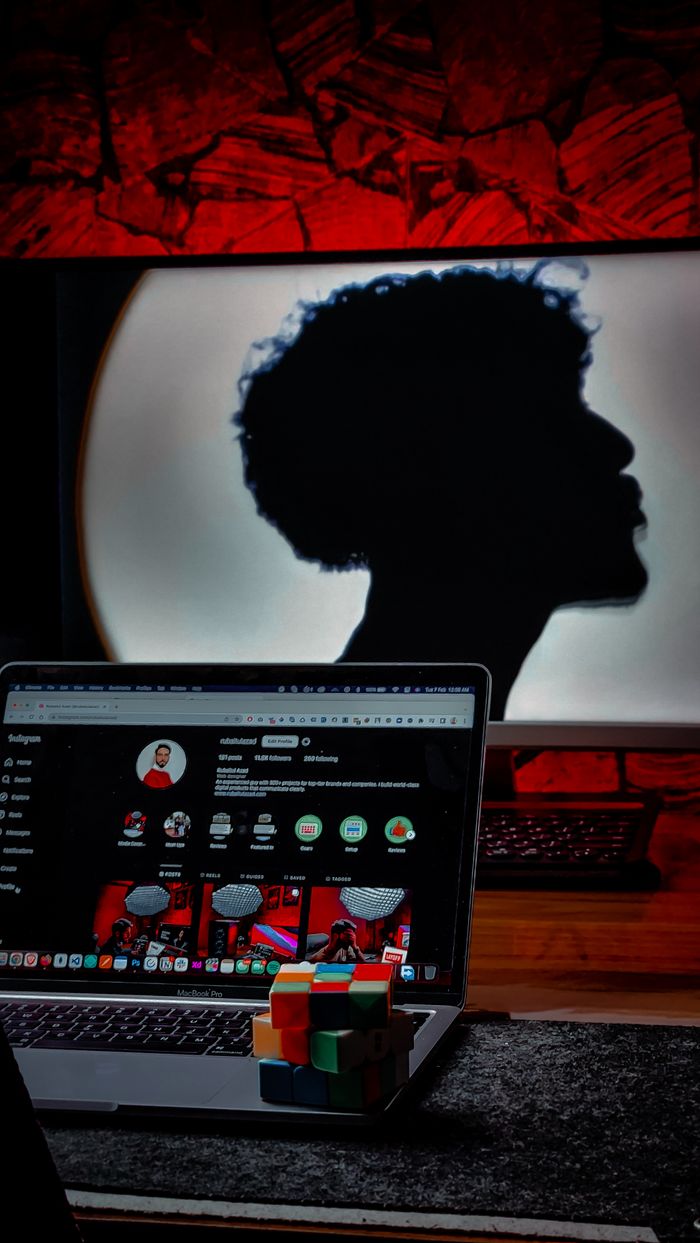 Home Silhouette of person behind laptop with Rubik